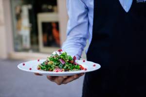 waiter serving a salad